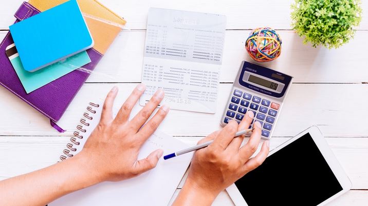 Funcionário de RH calculando fechamento de folha de pagamento